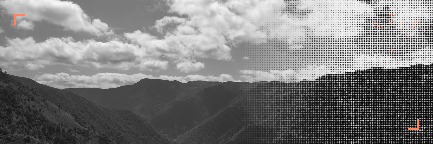 Mountain landscape, half photography and half halftone, with small orange corner marks